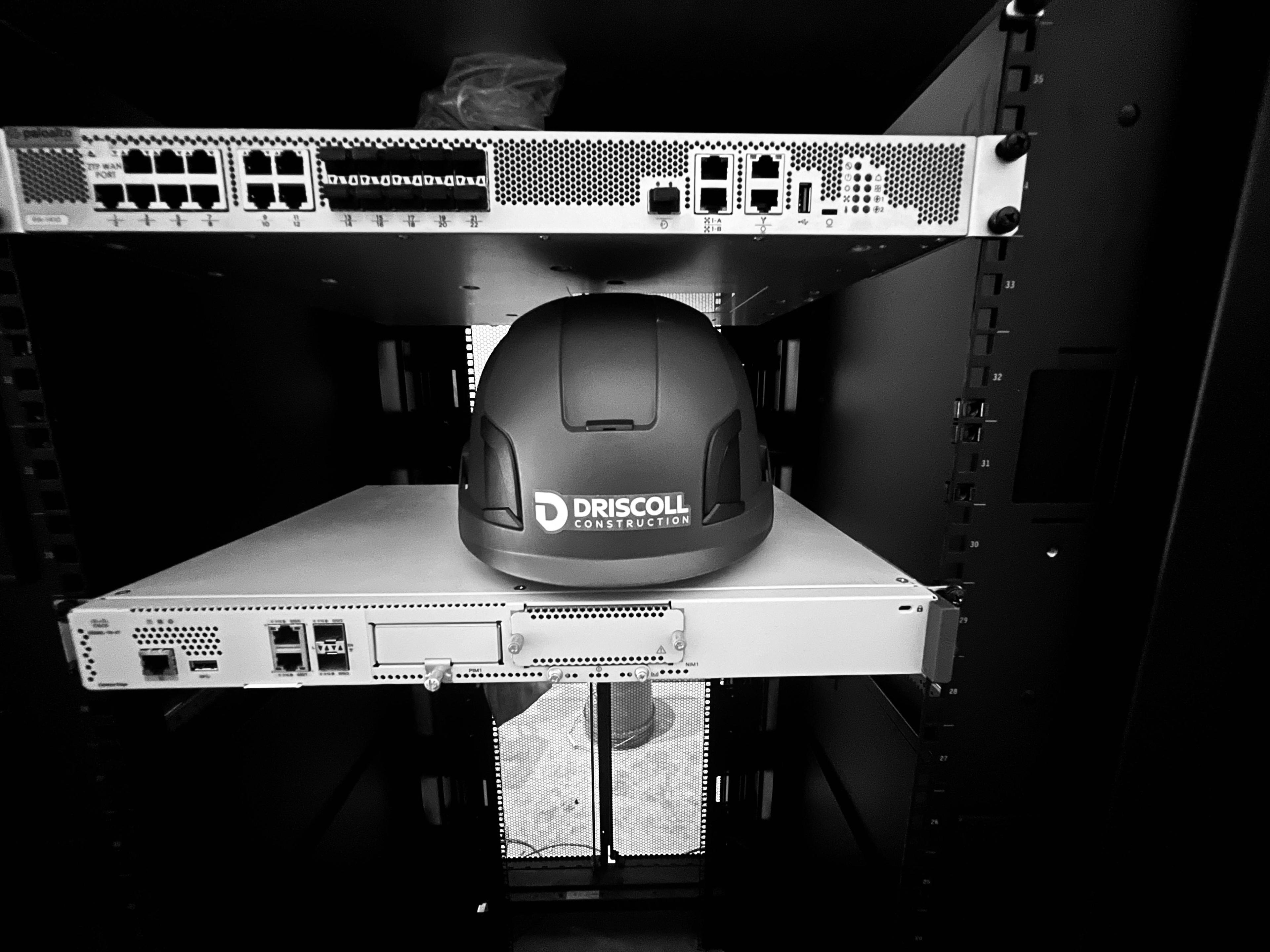 Driscoll Construction branded helmet in a controlled equipment environment